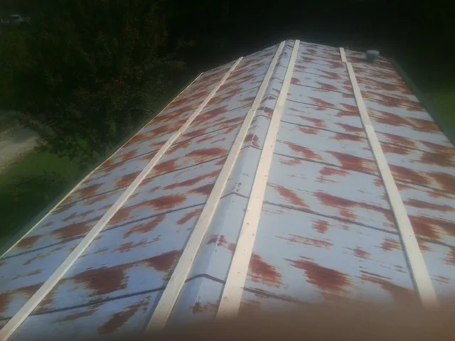 Rusted metal roof panels with new wood purlins before replacement — Storm Damage Roof Repair in Alburtis by Roofing Brothers